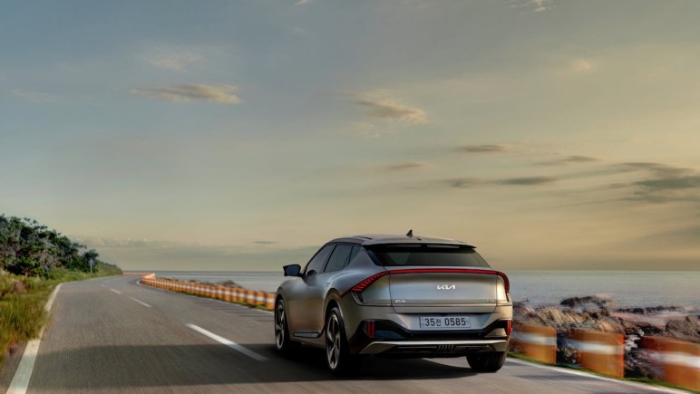 ELECTRIC VEHICLE DRIVING DOWN THE ROAD