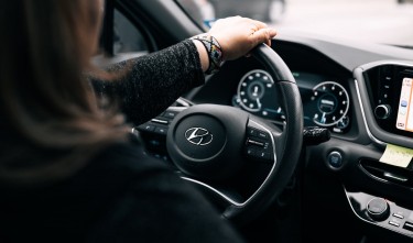 WOMAN SITTING INSIDE A CAR HYUNDAI