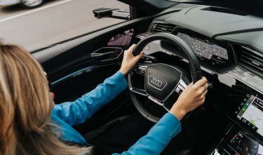 WOMAN DRIVING A NEW AUDI CAR