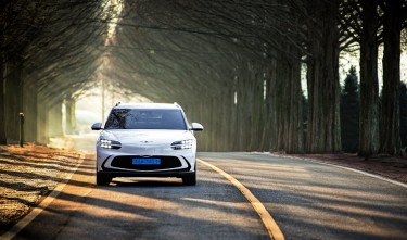 GRAYSCALE PHOTO OF A HYUNDAI IONIQ 5 IN THE RAIN