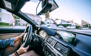 ANONYMOUS WOMAN DRIVING CAR IN TOWN