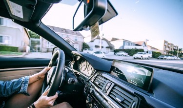 ANONYMOUS WOMAN DRIVING CAR IN TOWN