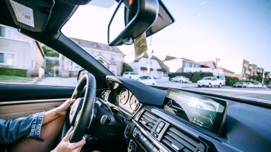 ANONYMOUS WOMAN DRIVING CAR IN TOWN