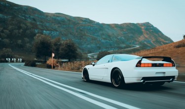 WHITE SPORTS CAR ON THE ROAD HONDA