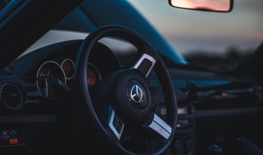 CLOSE UP OF THE STEERING WHEEL AND DASHBOARD IN A MODERN MAZDA MX-5