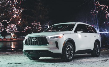 INFINITI Q60 AMONG CHRISTMAS LIGHT AT NIGHT