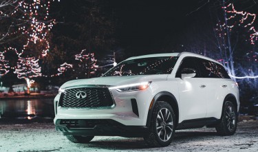 INFINITI Q60 AMONG CHRISTMAS LIGHT AT NIGHT