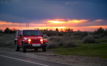 RED JEEP SUV BESIDE ROAD