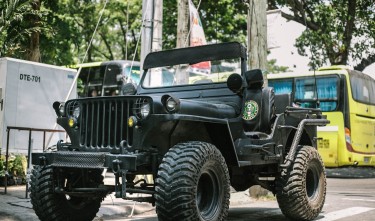 BLACK JEEP ACROSS YELLOW BUS