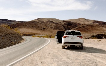 WHITE VEHICLE PARKED BESIDE ROAD,GMC