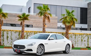 WHITE MASERATI CAR PARKED NEAR PALM TREES