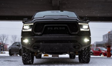 LOW ANGLE SHOT OF A BLACK RAM PICKUP TRUCK ON A PARKING LOT 