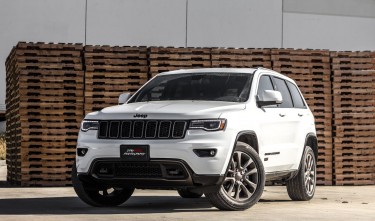 WHITE JEEP CHEROKEE SUV NEAR STACKED BROWN PALLET BOARDS