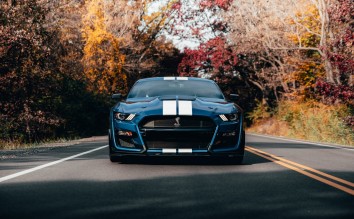 PHOTO OF BLUE MUSTANG ON ROAD FORD