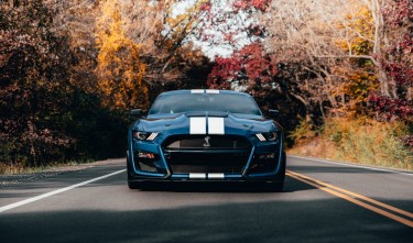 PHOTO OF BLUE MUSTANG ON ROAD FORD