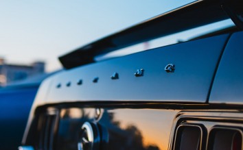 CLOSE UP OF THE TRUNK OF A CLASSIC FORD MUSTANG