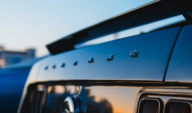 CLOSE UP OF THE TRUNK OF A CLASSIC FORD MUSTANG