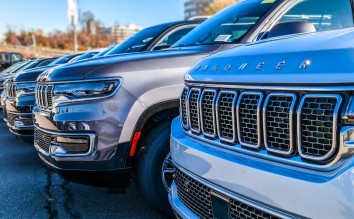 NEW JEEP WAGONEERS ON A PARKING LOT AT A CAR DEALERSHIP