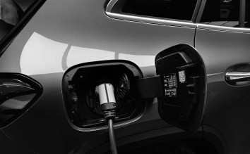 MONOCHROME PHOTO  OF HYBRID CAR CHARGING