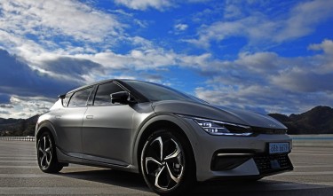 PHOTO OF A CAR UNDER A CLOUDY SKY KIA