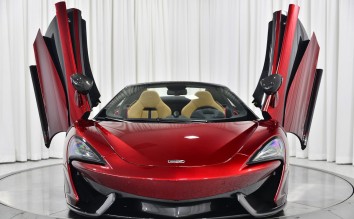 A BEAUTIFUL SHINY MCLAREN CAR WITH AN OPEN DOORS