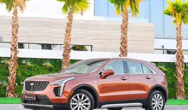 BROWN CAR PARKED NEAR PALM TREES CADILLAC