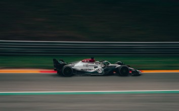 TIME LAPSE PHOTOGRAPHY OF GREEN AND WHITE RACING VEHICLE ON LANE 