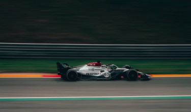 TIME LAPSE PHOTOGRAPHY OF GREEN AND WHITE RACING VEHICLE ON LANE 