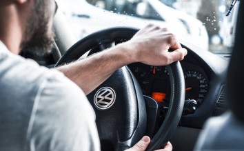 PERSON HOLDING STEERING WHEEL VOLKSWAGEN