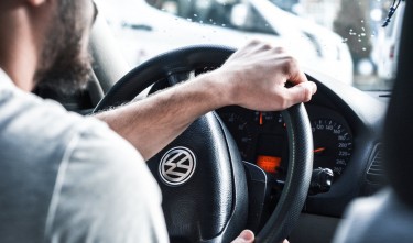 PERSON HOLDING STEERING WHEEL VOLKSWAGEN