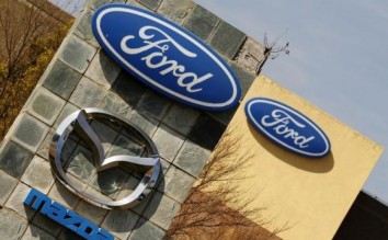 Ford shares tumble on lower profit outlook for 2014-2015