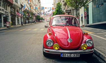 Red Beetle parked at the roadside near pedestrian lane 