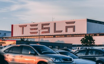 CARS PARKED IN FRONT OF COMPANY BUILDING 