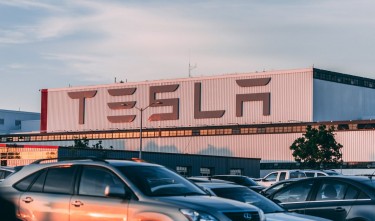 CARS PARKED IN FRONT OF COMPANY BUILDING 