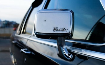 BLACK CADILLAC WITH CHROME SIDE MIRROR