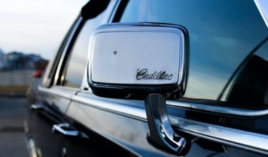 BLACK CADILLAC WITH CHROME SIDE MIRROR