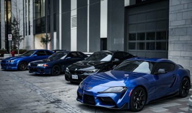 SPORTS CAR IN FRONT OF CAR SHOWROOM