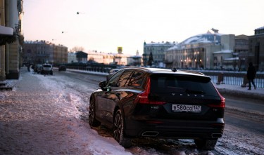 CAR PARKED IN SNOW BY SIDEWALK 