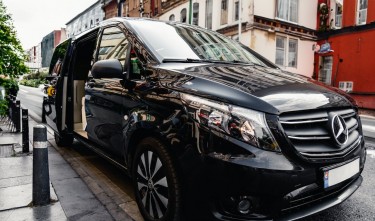 BLACK MERCEDES V CLASS PARKED BY THE SIDE DOOR OPEN