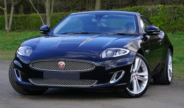 A BLACK JAGUAR PARKED ON THE ROADSIDE