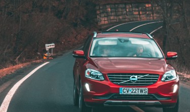 RED MIDSIZE SUV CAR ON ROAD