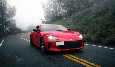 A RED TOYOTA GR86 ON AN ASPHALT ROAD