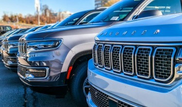 NEW JEEP WAGONEERS ON A PARKING LOT AT A CAR DEALERSHIP