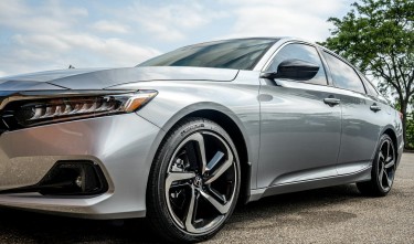 A SILVER HONDA ACCORD PARKED ON THE STREET