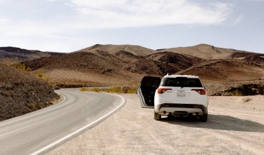 WHITE VEHICLE PARKED BESIDE ROAD,GMC