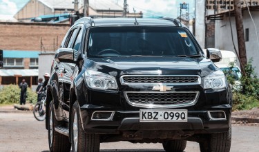  A BLACK CHEVROLET ON THE ROAD 