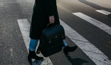 PERSONC CARRYING BAG WALKING ON PEDESTRIAN LANE 