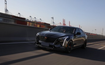 PHOTO OF A BLACK CADILLAC ON THE ROAD