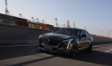 PHOTO OF A BLACK CADILLAC ON THE ROAD