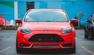 RED CAR PARKED ON PARKING LOT